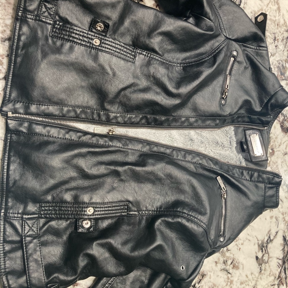 A black leather jacket with fur inside. For kids.